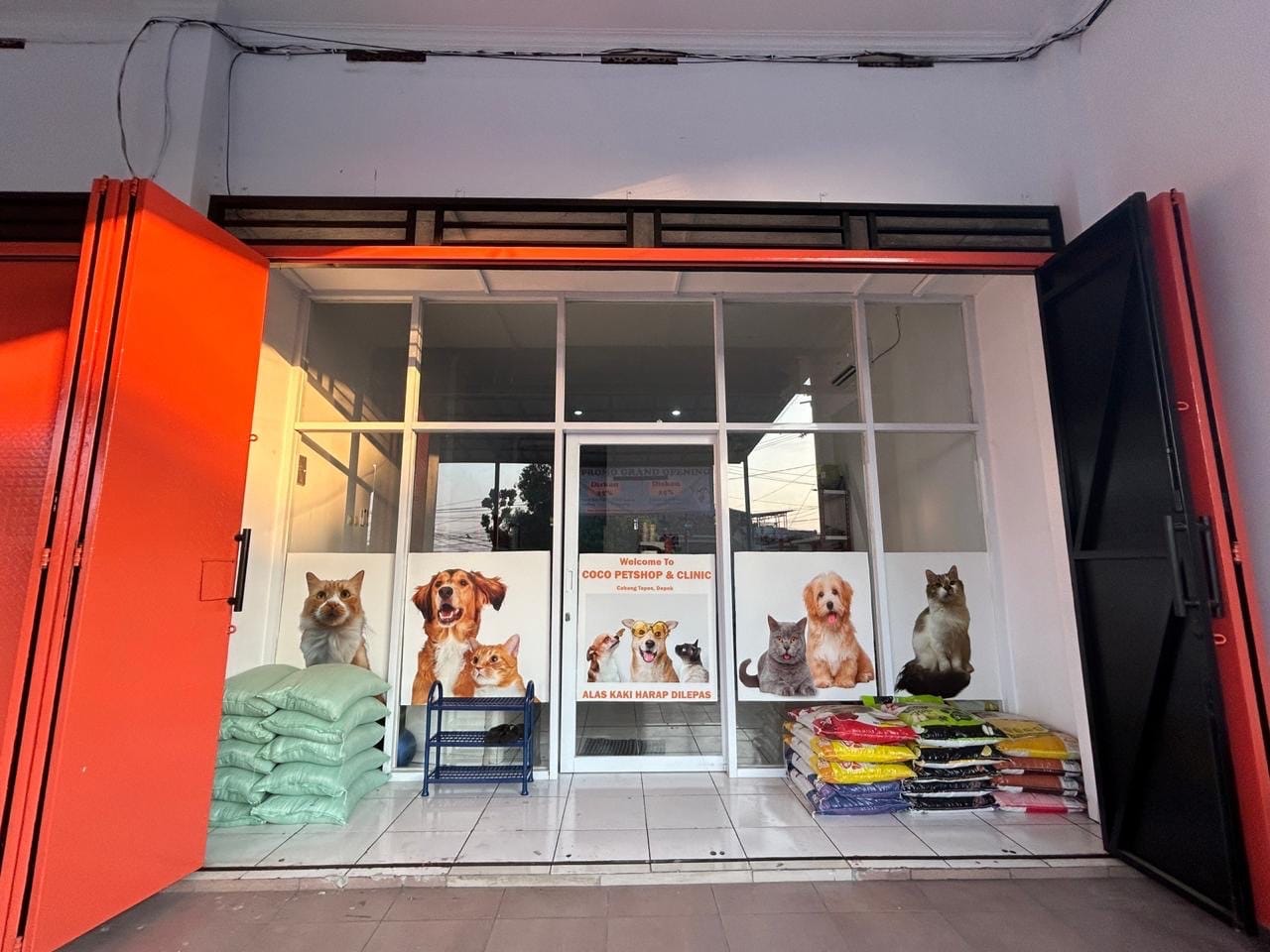 Pintu toko coco petshop tapos dengan papan iklan kucing dan anjing